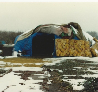 Sweat lodge surrounded by half melted snow