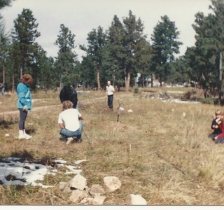 a group of people picking the location to set up sweat lodge